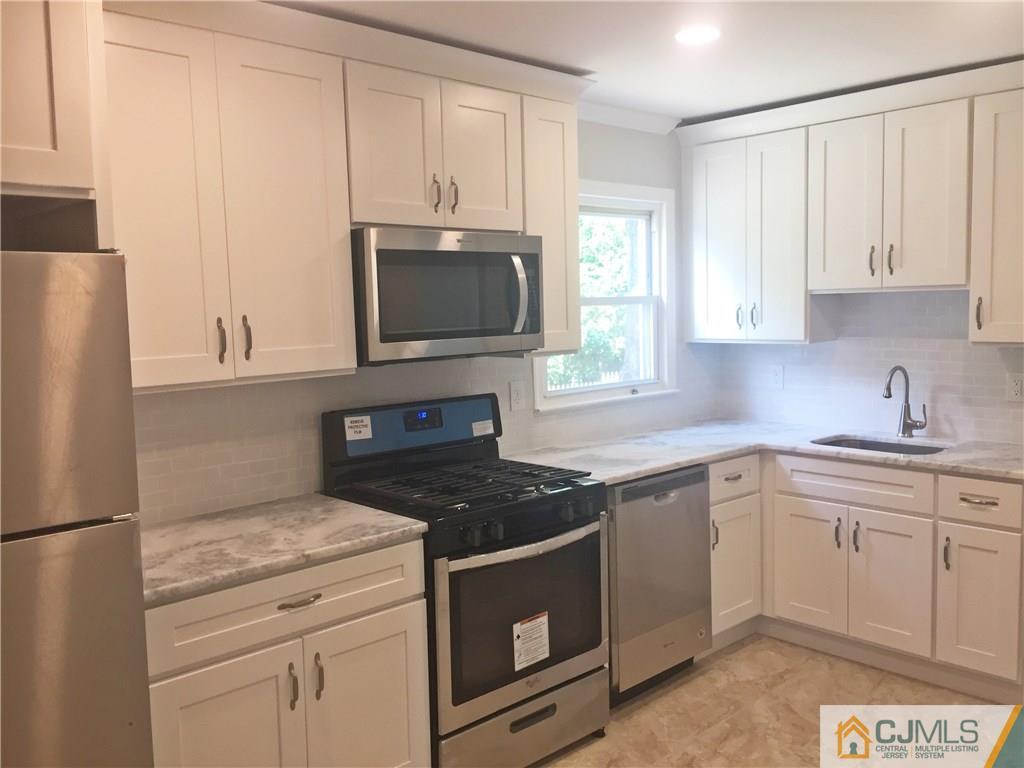 38 Sine Road Edison, NJ 08817 - Photo 6 of 15 a kitchen with cabinets appliances a sink and a window