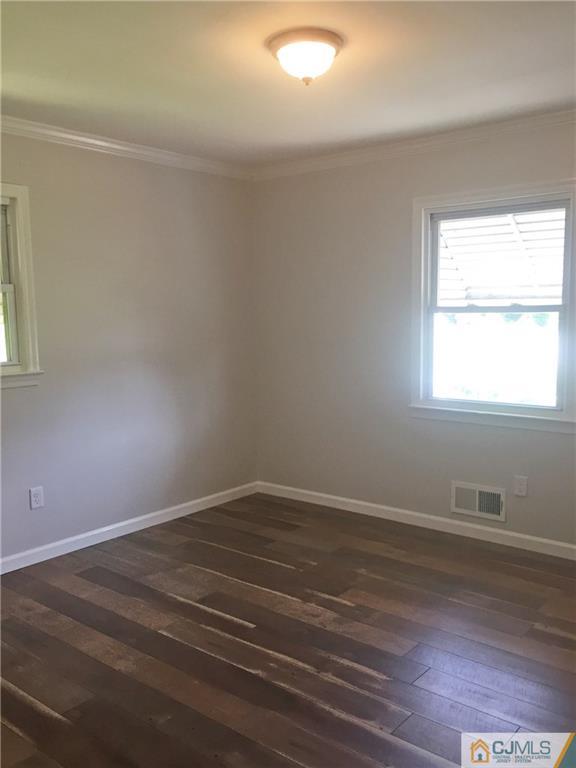 38 Sine Road Edison, NJ 08817 - Photo 7 of 15 an empty room with wooden floor and windows