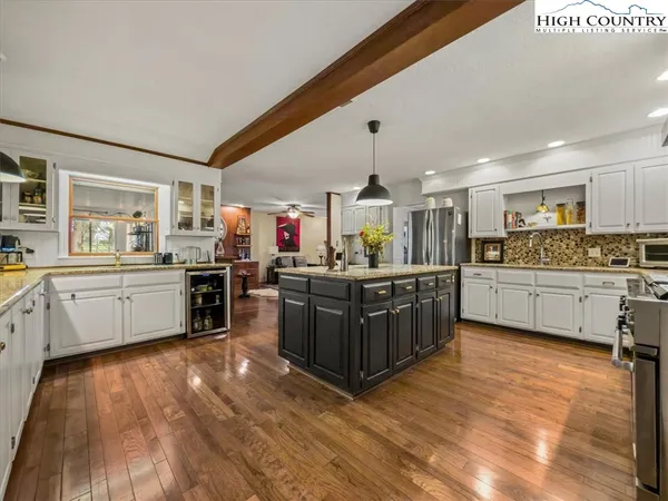 a kitchen with granite countertop a sink stainless steel appliances and cabinets