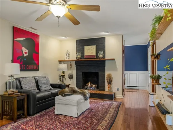 a living room with furniture large window and rug