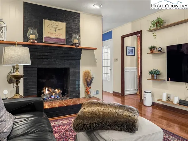 a living room with furniture a clock and a large window
