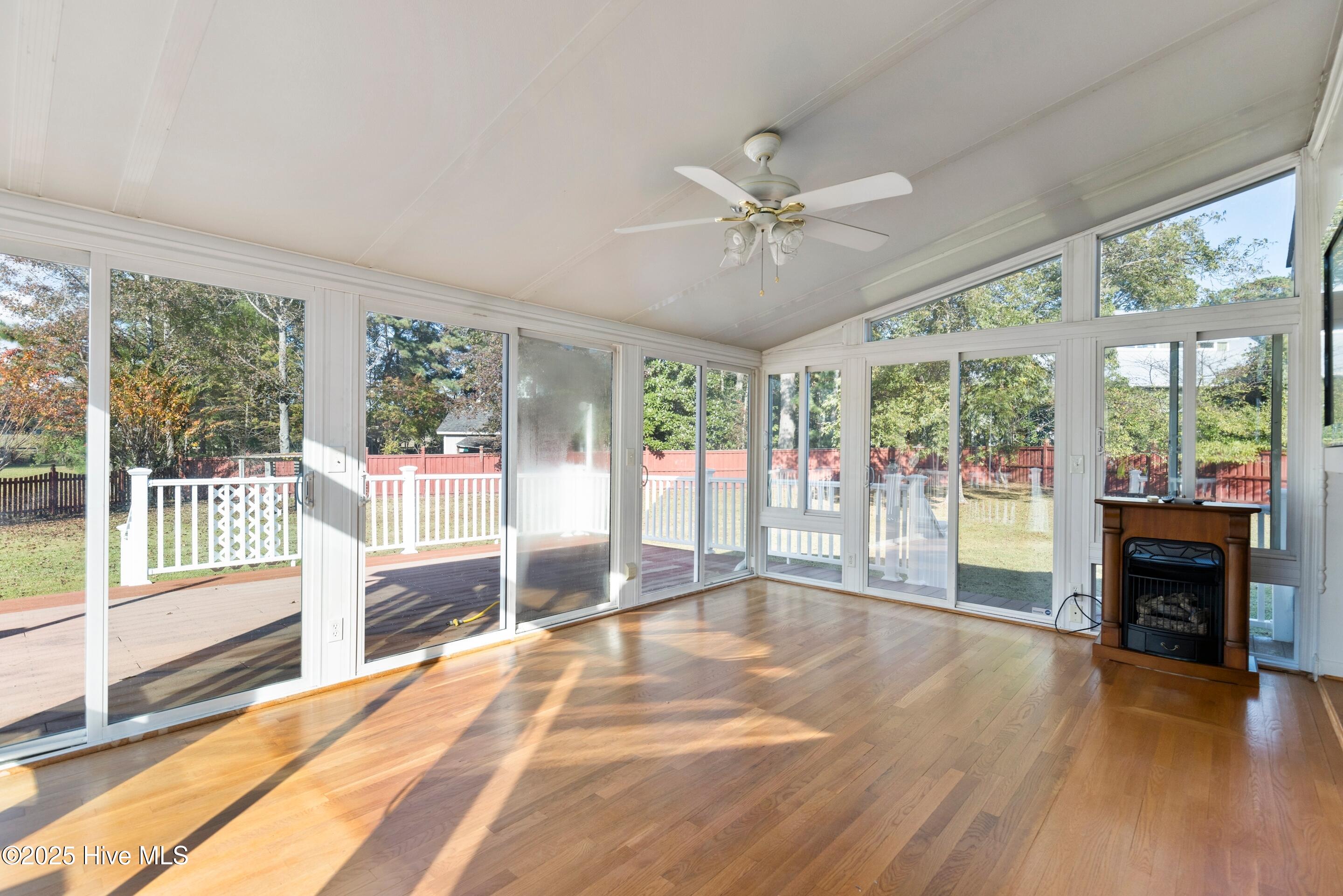 1501 Field View Road Wilmington, NC 28411 - Photo 23 of 57 Sunroom surrounded with natural light adorned in hardwood floors.