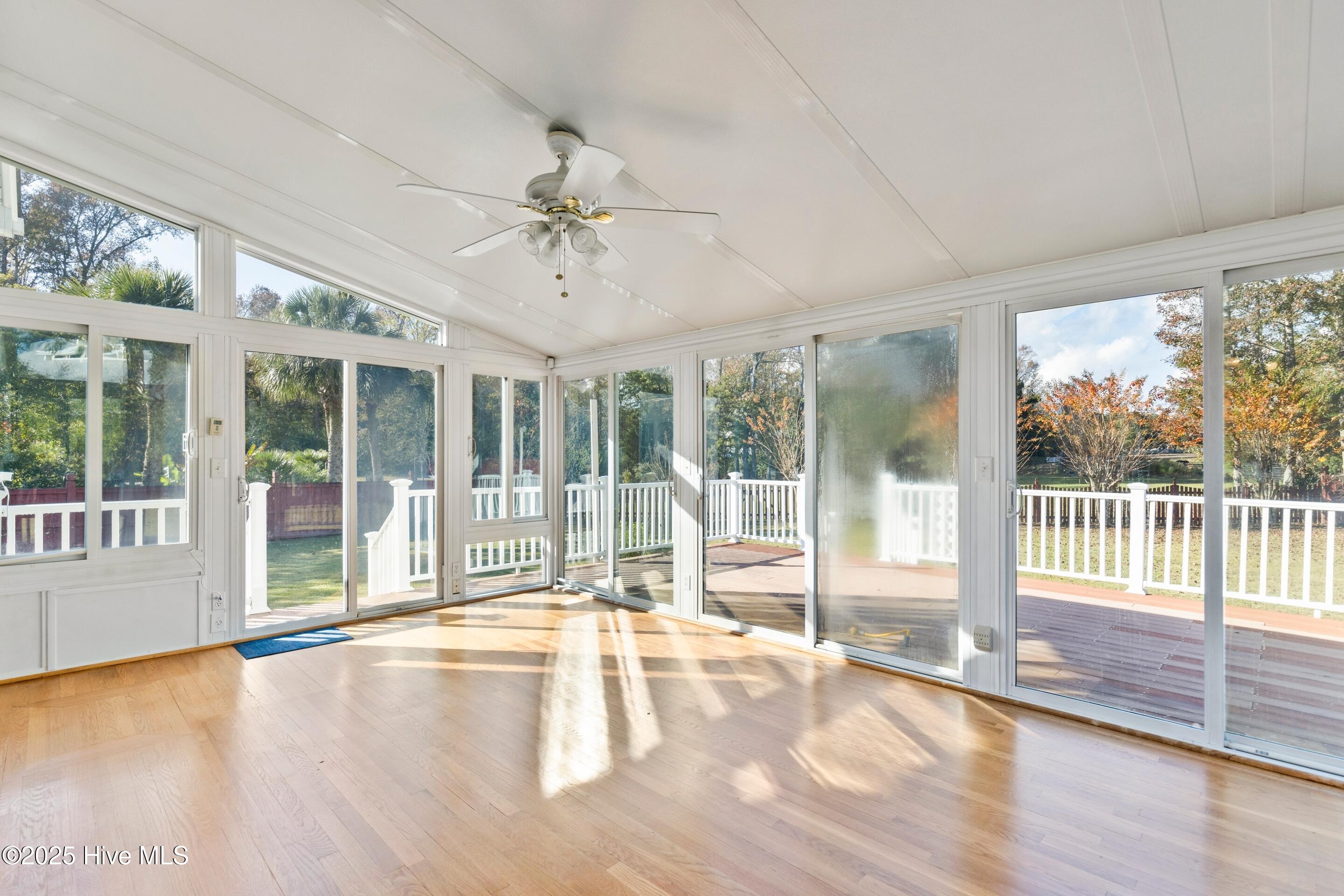 1501 Field View Road Wilmington, NC 28411 - Photo 25 of 57 Sunroom with hardwood floors, flooded with natural light.