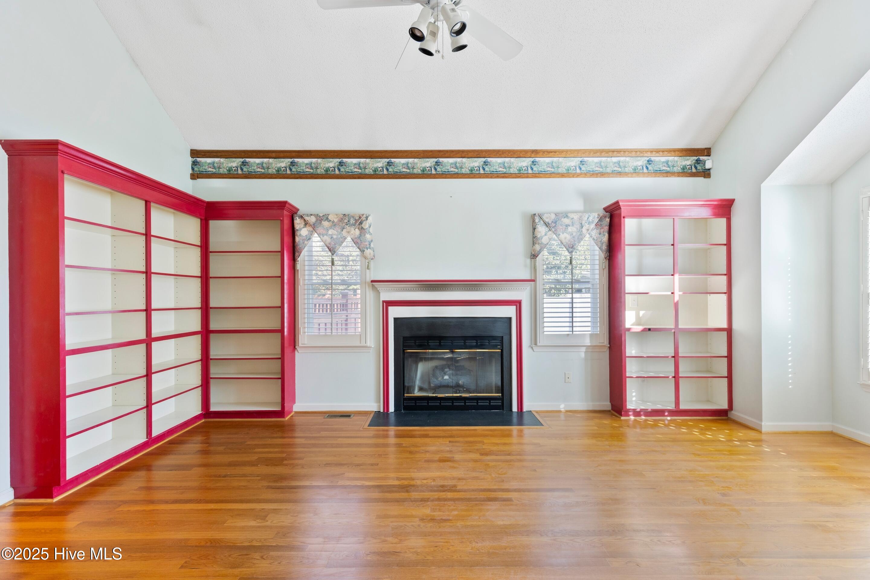 1501 Field View Road Wilmington, NC 28411 - Photo 6 of 57 Formal Living room with vaulted ceiling, gas fireplace, hardwood floors and bookcases.