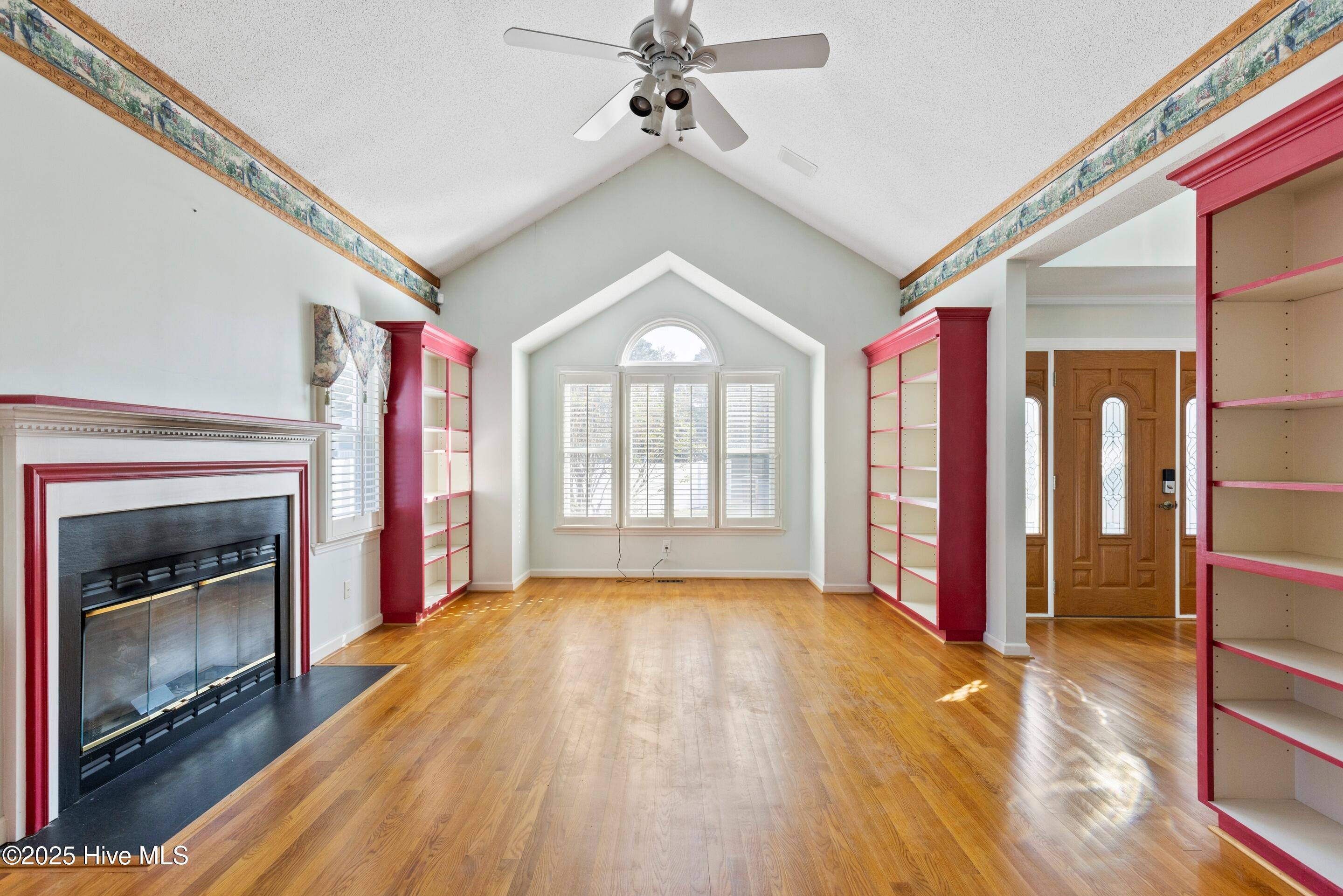 1501 Field View Road Wilmington, NC 28411 - Photo 8 of 57 Formal living room with vaulted ceiling, hardwood floors, bookcases and gas fireplace.