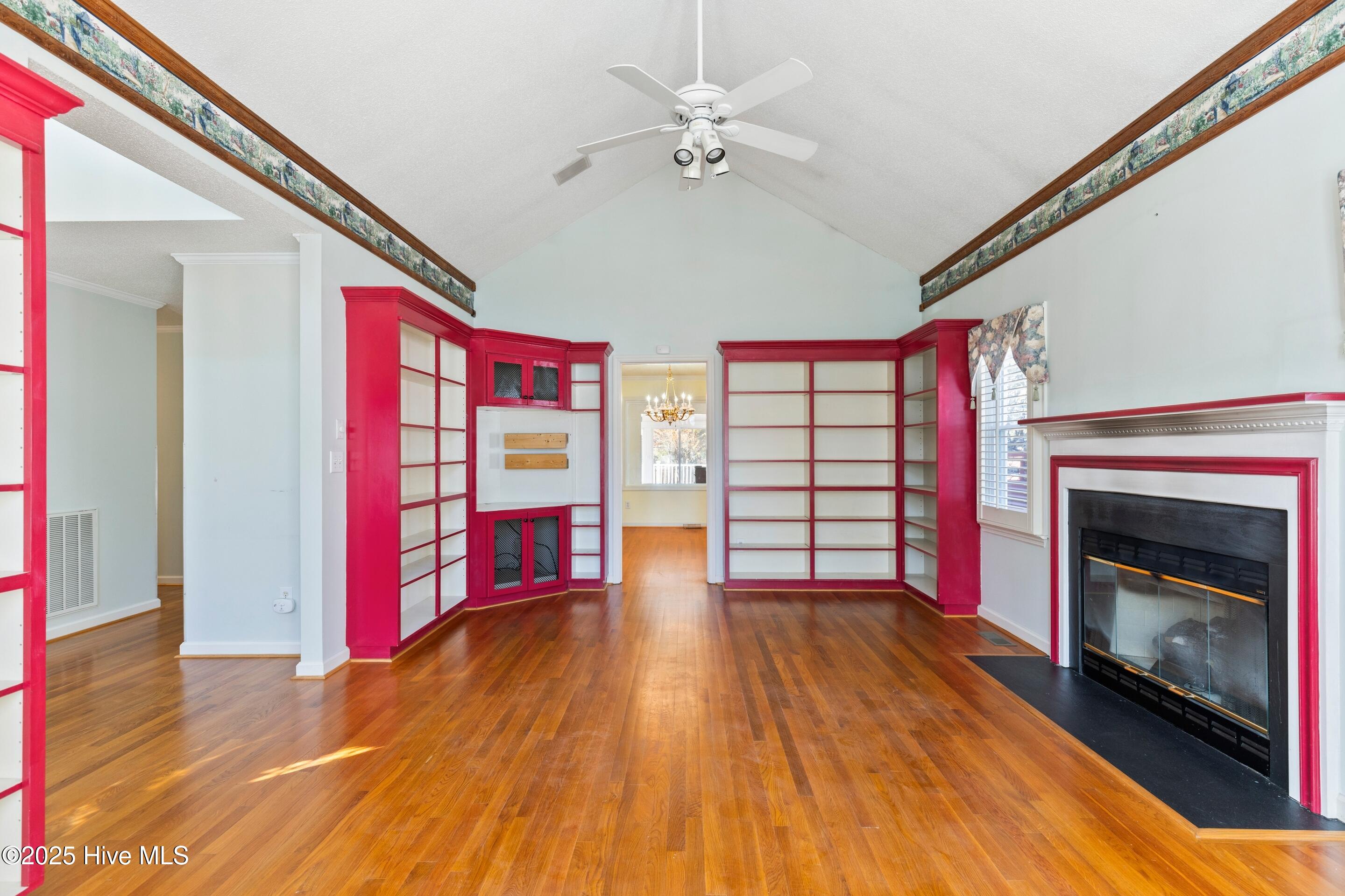 1501 Field View Road Wilmington, NC 28411 - Photo 9 of 57 Formal living room with hardwood floors, vaulted ceilings, bookcases and gas fireplace.