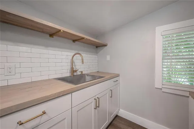 a kitchen with a sink and cabinets