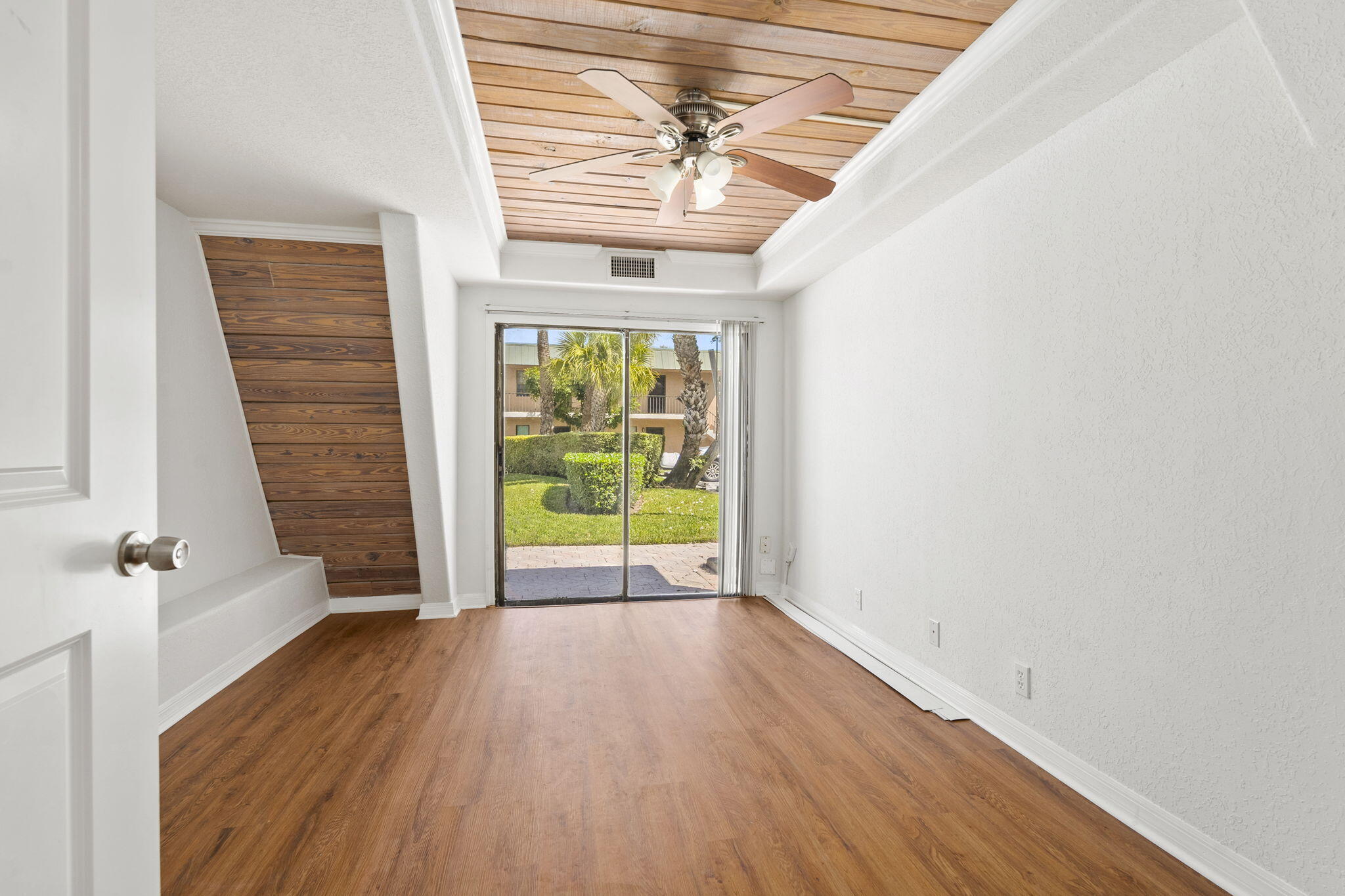 1001 Southeast Monterey Road Stuart, FL 34994 - Photo 11 of 17 wooden floor in an empty room with a window