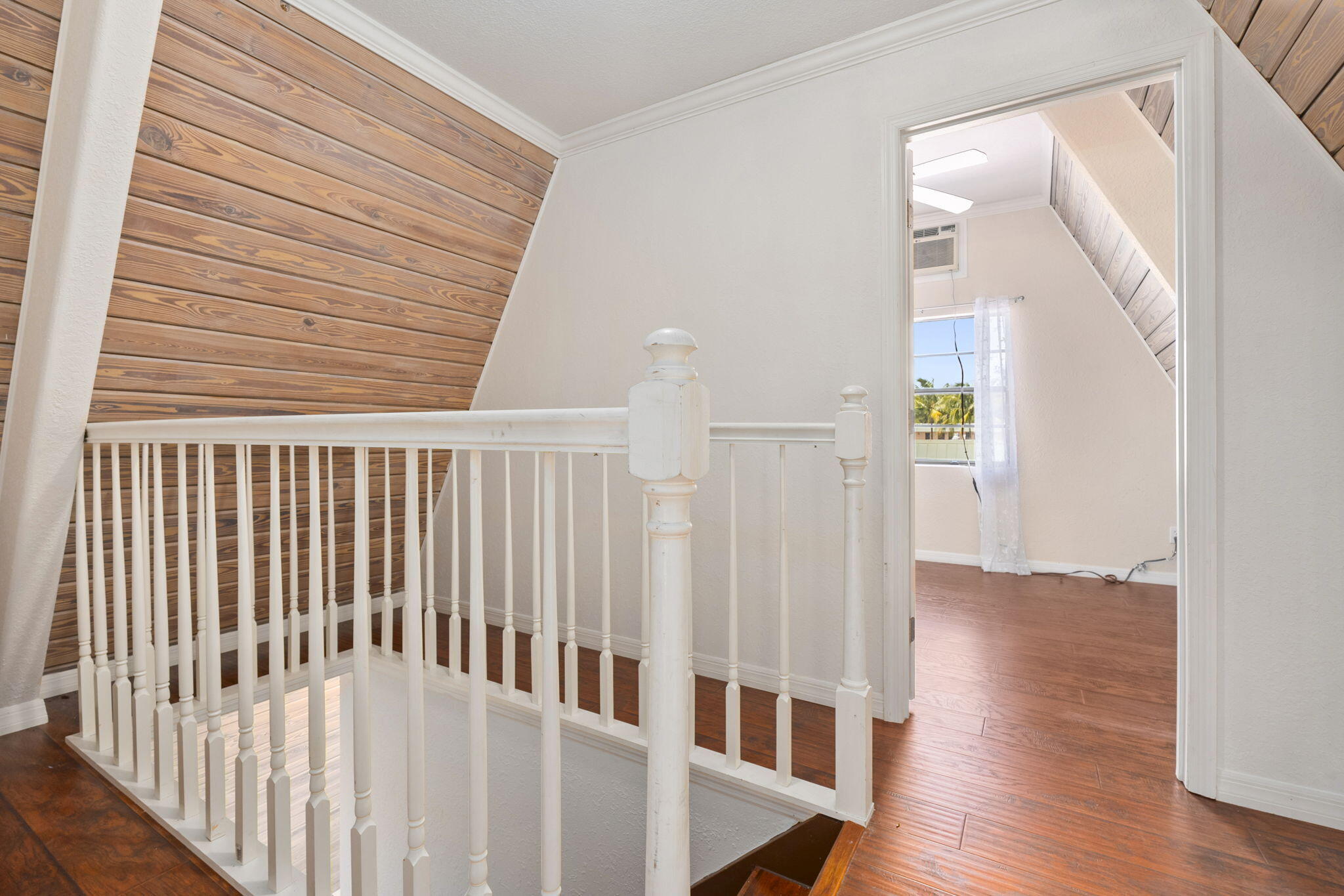 1001 Southeast Monterey Road Stuart, FL 34994 - Photo 14 of 17 a view of a hallway with wooden floor