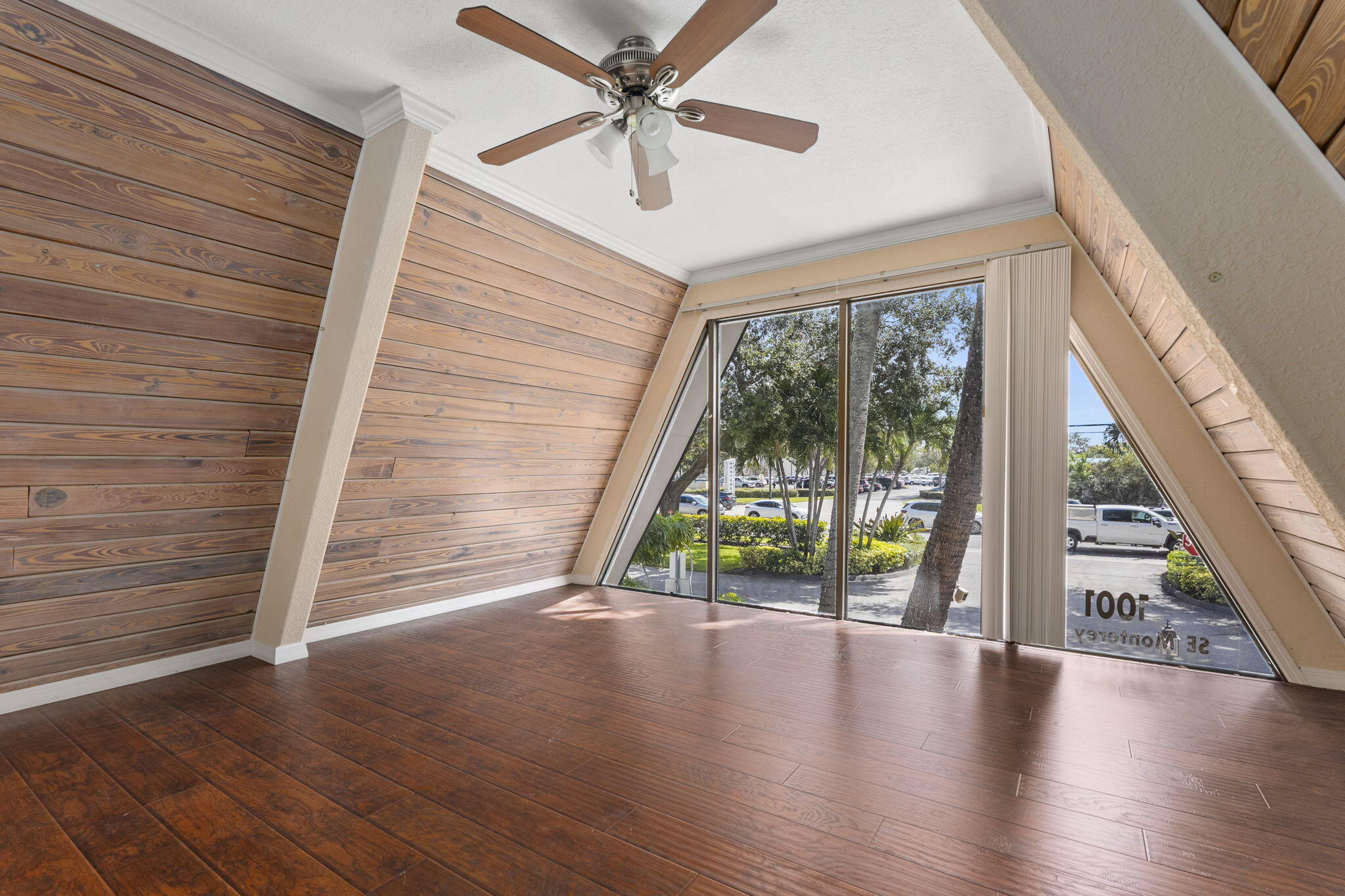 1001 Southeast Monterey Road Stuart, FL 34994 - Photo 16 of 17 wooden floor in an empty room with a window