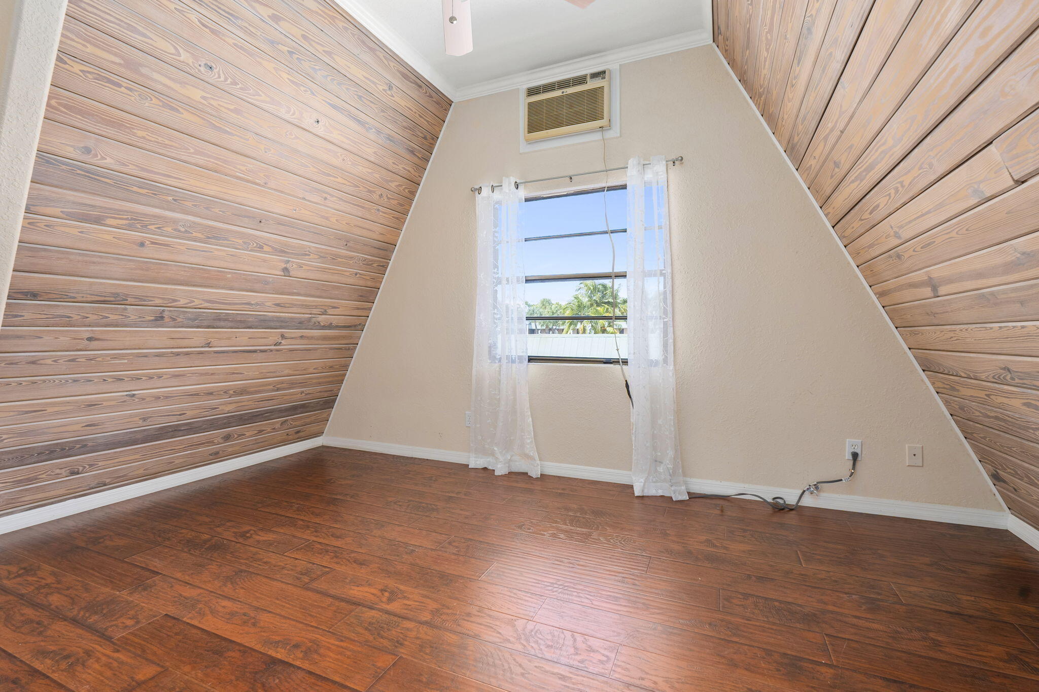1001 Southeast Monterey Road Stuart, FL 34994 - Photo 17 of 17 a view of an empty room with wooden floor and stairs
