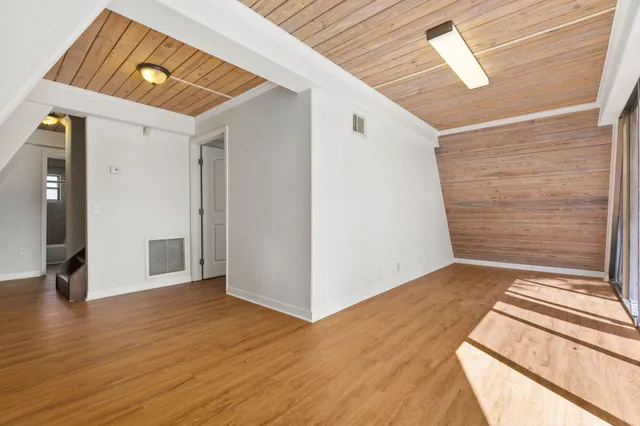 a view of a hallway view with wooden floor and staircase