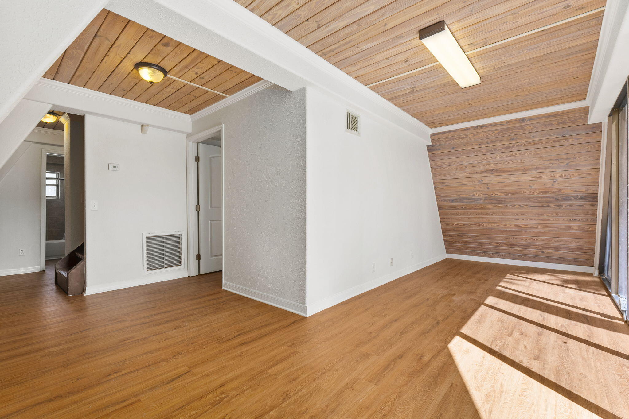 1001 Southeast Monterey Road Stuart, FL 34994 - Photo 4 of 17 a view of a hallway view with wooden floor and staircase