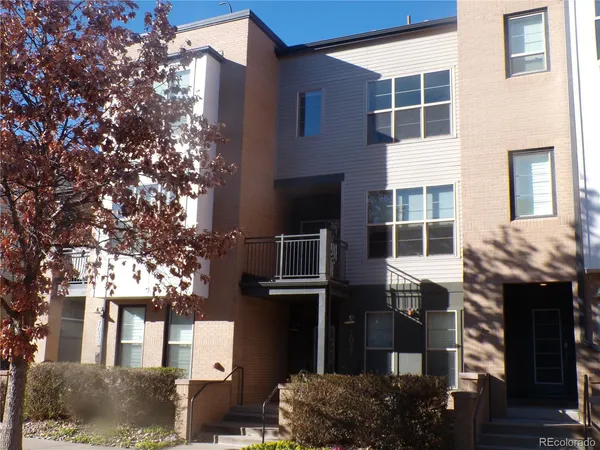 a front view of a building with a tree