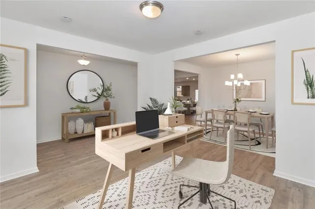 a living room with furniture a mirror and wooden floor