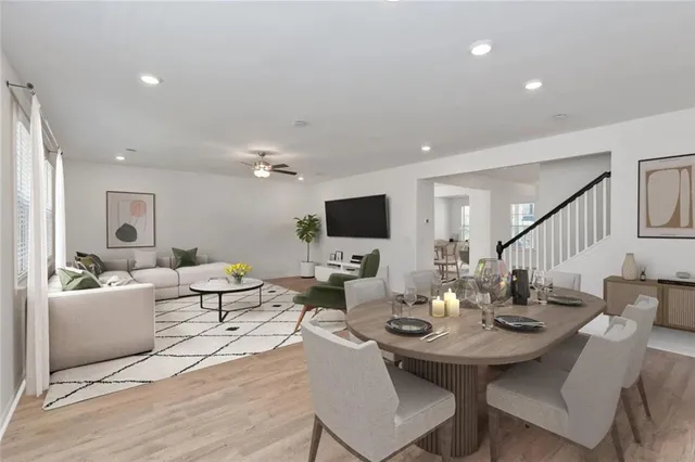 a living room with furniture kitchen view and a flat screen tv