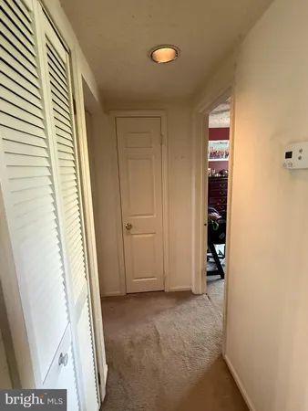 a view of an empty room and a bathroom
