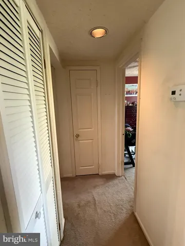 a view of an empty room and a bathroom