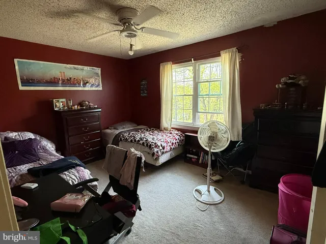 a bedroom with furniture and a lamp