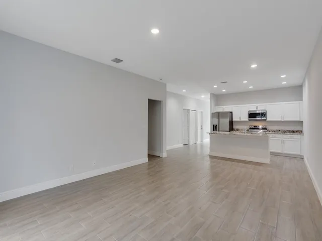a view of kitchen with kitchen island and stainless steel appliances