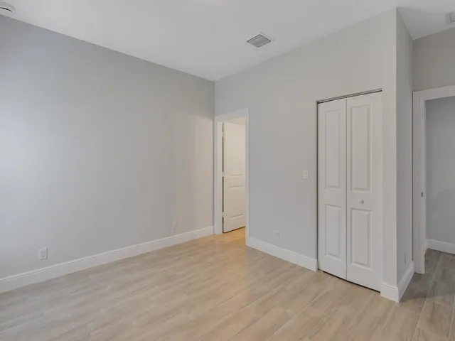 a view of an empty room and wooden floor