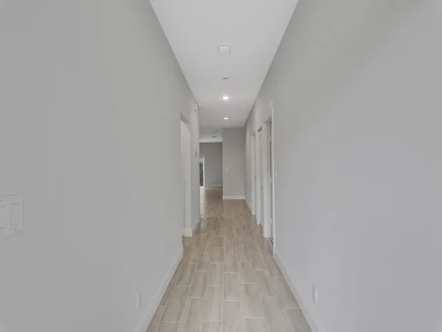 a view of a hallway with wooden floor