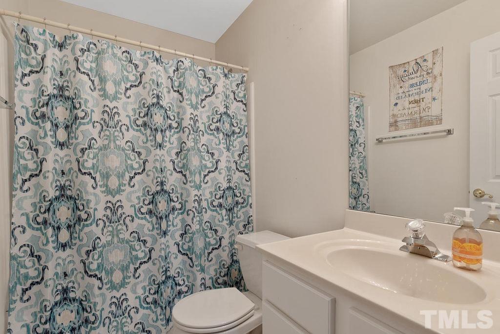 4711 Longhill Lane Raleigh, NC 27612 - Photo 14 of 27 a bathroom with a sink toilet and a mirror