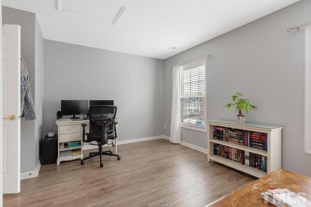 4711 Longhill Lane Raleigh, NC 27612 - Photo 18 of 27 a workspace with furniture window and wooden floor