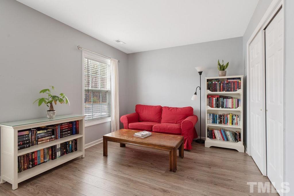 4711 Longhill Lane Raleigh, NC 27612 - Photo 20 of 27 a living room with furniture and a book shelf