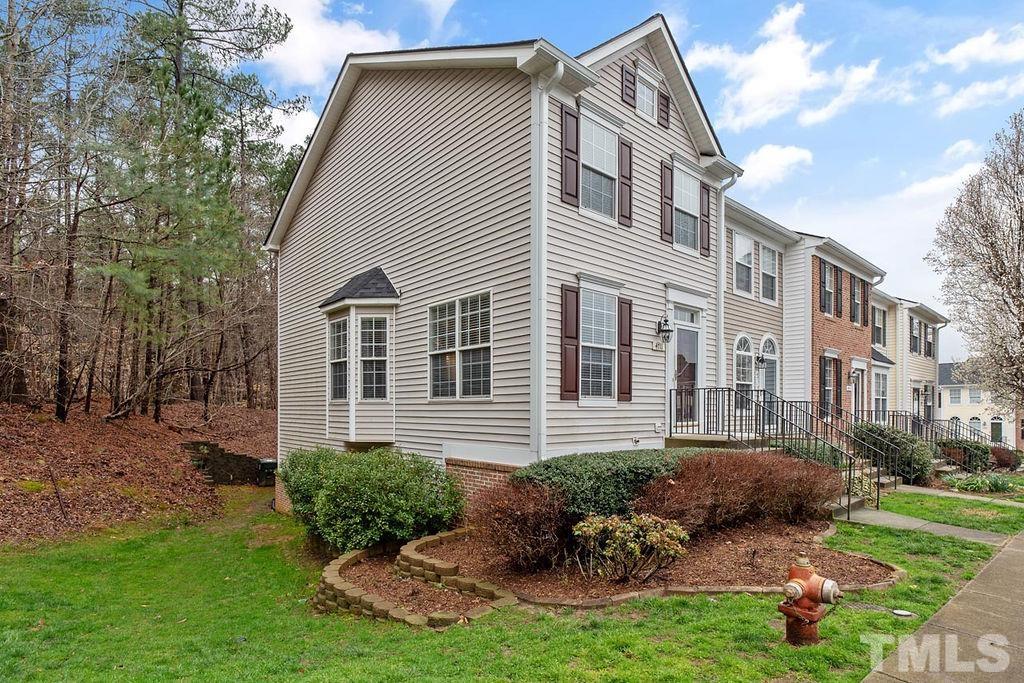 4711 Longhill Lane Raleigh, NC 27612 - Photo 2 of 27 a front view of a house with a yard and potted plants