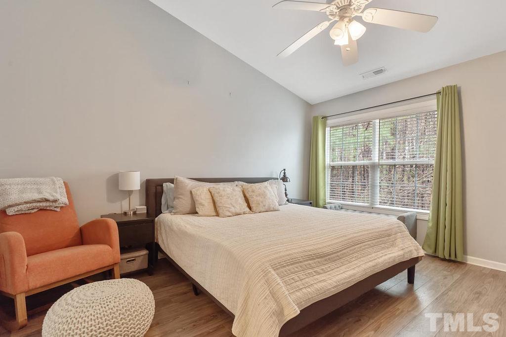 4711 Longhill Lane Raleigh, NC 27612 - Photo 23 of 27 a large bedroom with a bed and a couch