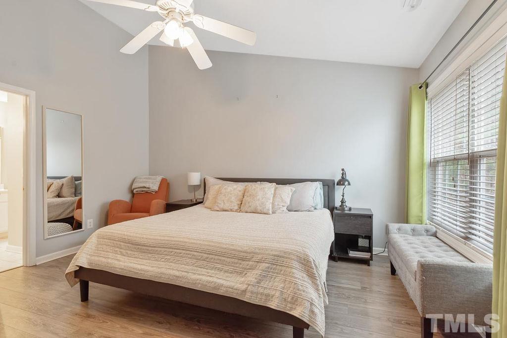 4711 Longhill Lane Raleigh, NC 27612 - Photo 24 of 27 a bedroom with bed and a large window