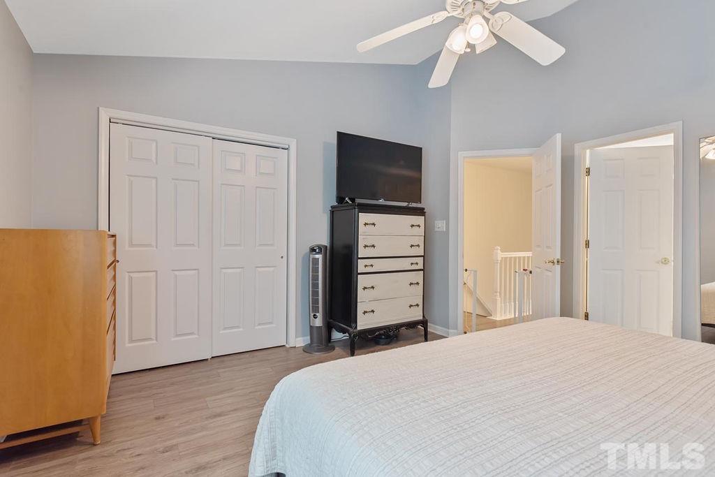 4711 Longhill Lane Raleigh, NC 27612 - Photo 25 of 27 a bedroom with a bed and a flat screen tv