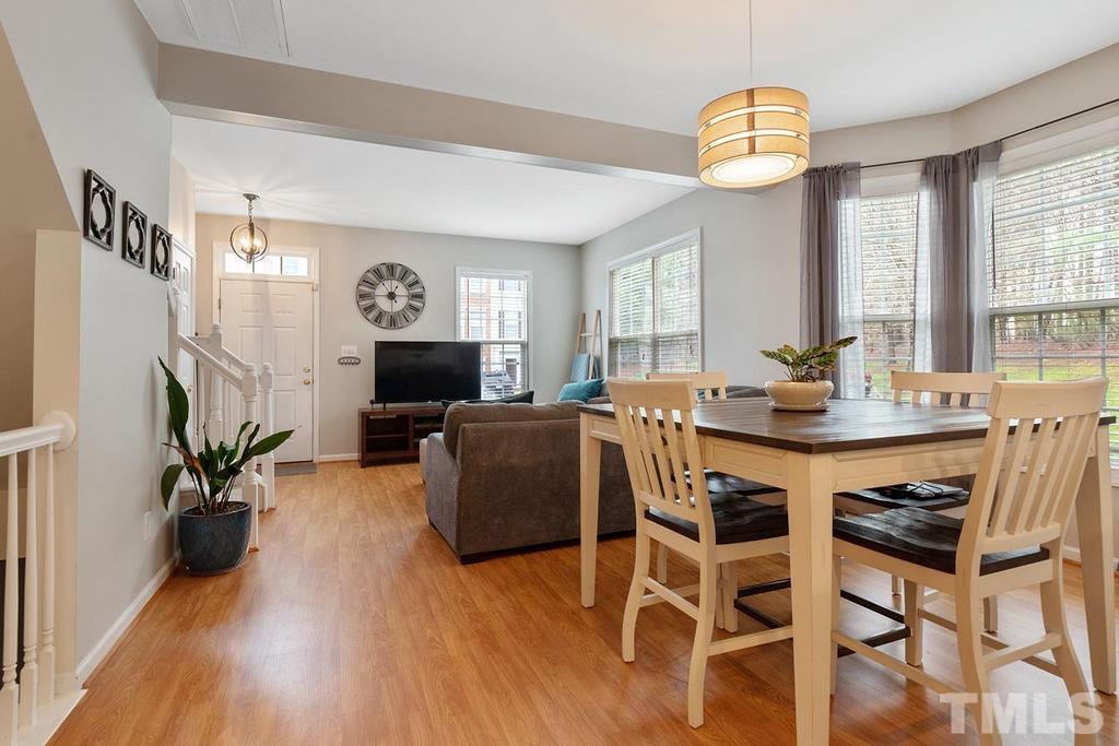 4711 Longhill Lane Raleigh, NC 27612 - Photo 7 of 27 a view of a dining room with furniture window and wooden floor