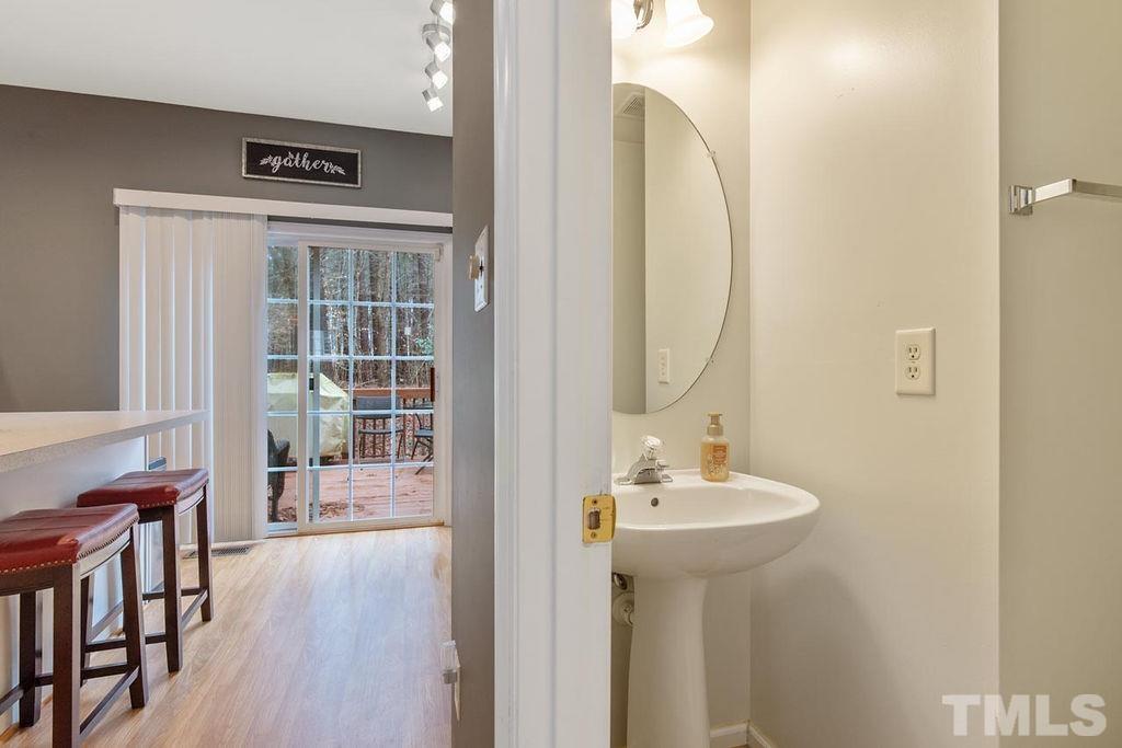 4711 Longhill Lane Raleigh, NC 27612 - Photo 8 of 27 a bathroom with a sink a mirror and a window