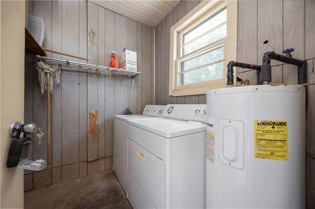 5201 Summerville Road Phenix City, AL 36867 - Photo 35 of 35 Laundry room with electric water heater, wooden walls, and independent washer and dryer