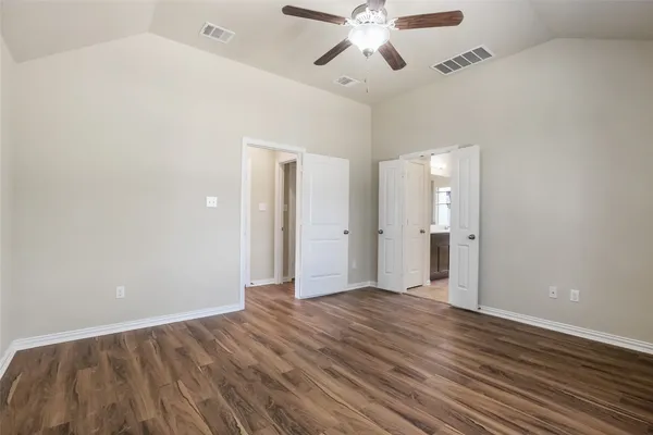 a view of an empty room and wooden floor