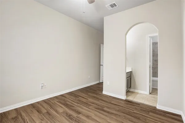 an empty room with wooden floor and closet