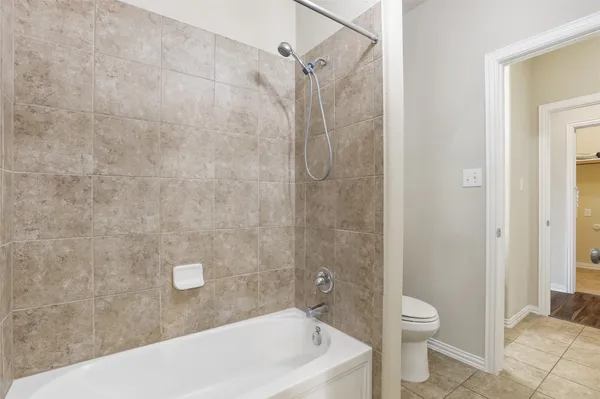 a bathroom with a bathtub and a toilet