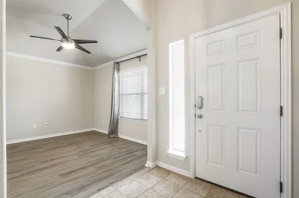 a view of an empty room with wooden floor