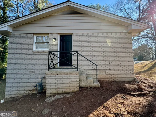 a view of house with brick walls