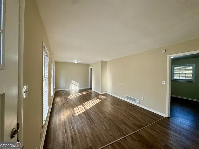 a view of an empty room and glass door