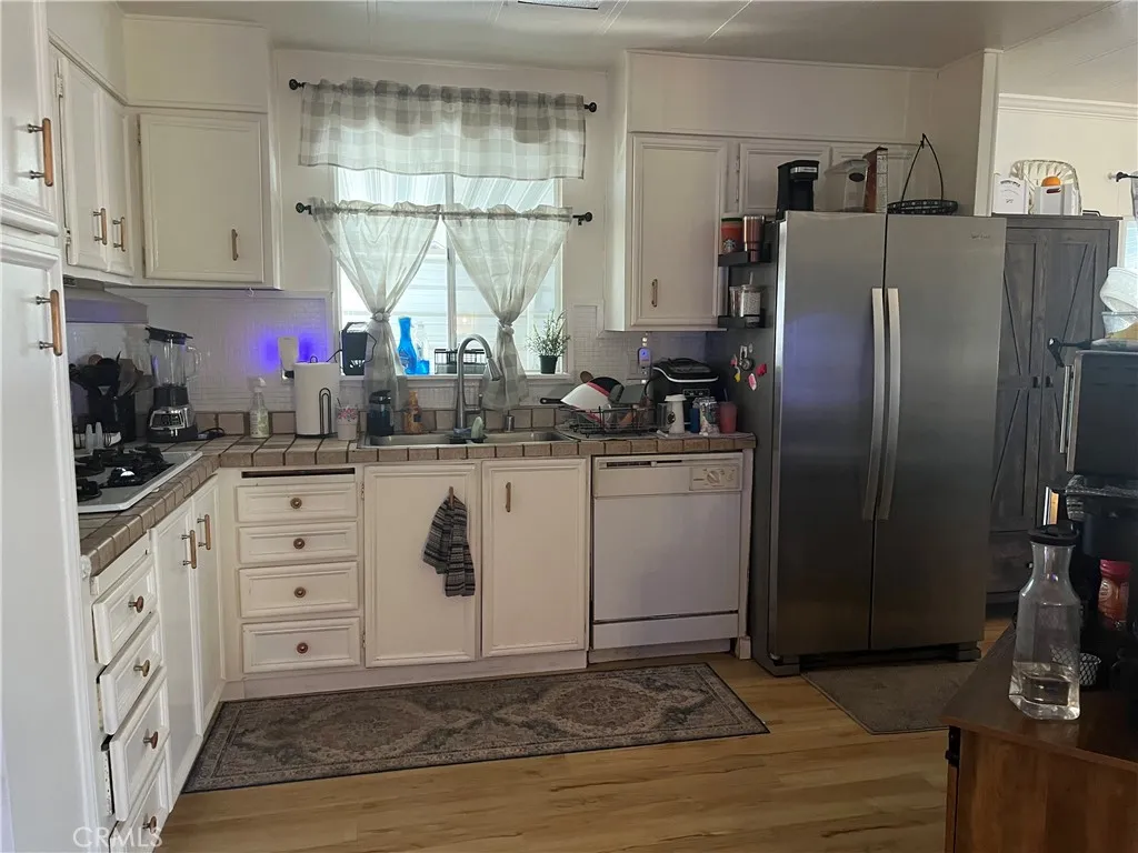 3700 Buchanan Street, Unit 98 Riverside, CA 92503 - Photo 13 of 18 a kitchen with stainless steel appliances a sink cabinets and a window