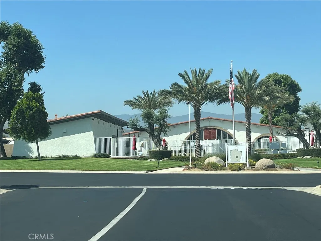 3700 Buchanan Street, Unit 98 Riverside, CA 92503 - Photo 2 of 18 a front view of a house with a garden and tree