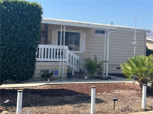 a view of a house with a yard and sitting area