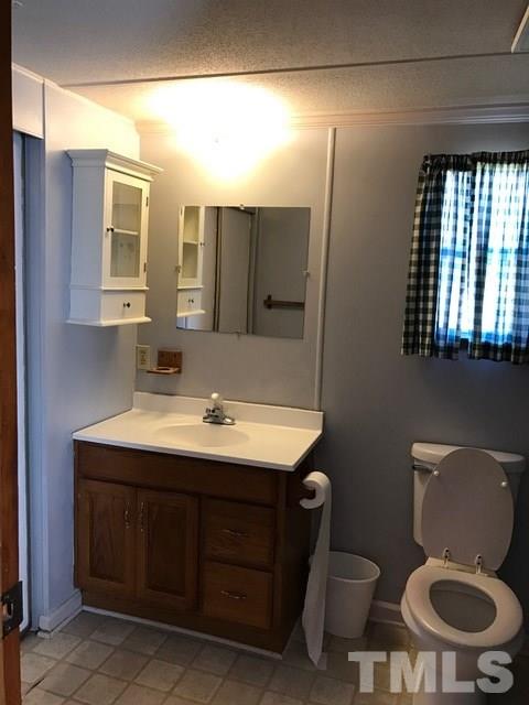 2017 Wiley Road Spring Hope, NC 27882 - Photo 14 of 23 a bathroom with a toilet sink and mirror