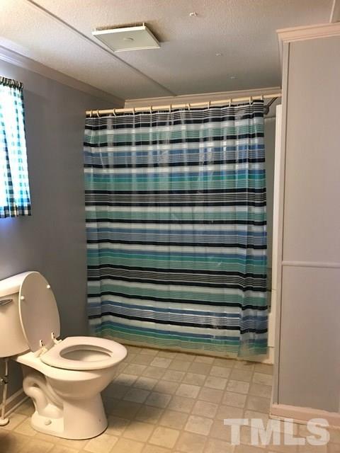 2017 Wiley Road Spring Hope, NC 27882 - Photo 15 of 23 a bathroom with a toilet and a shower