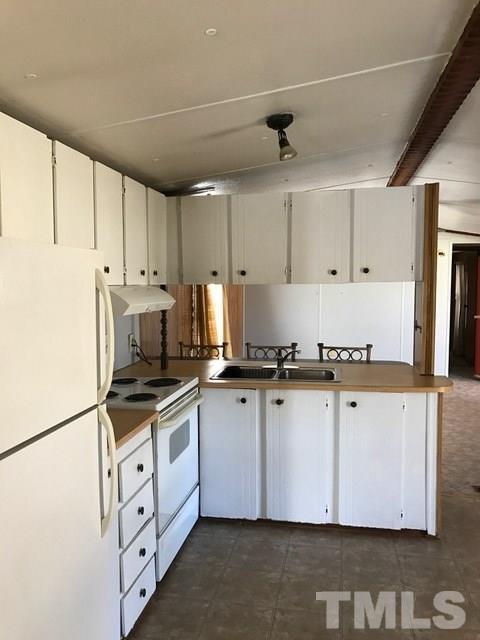2017 Wiley Road Spring Hope, NC 27882 - Photo 6 of 23 a kitchen with granite countertop a sink stainless steel appliances and cabinets