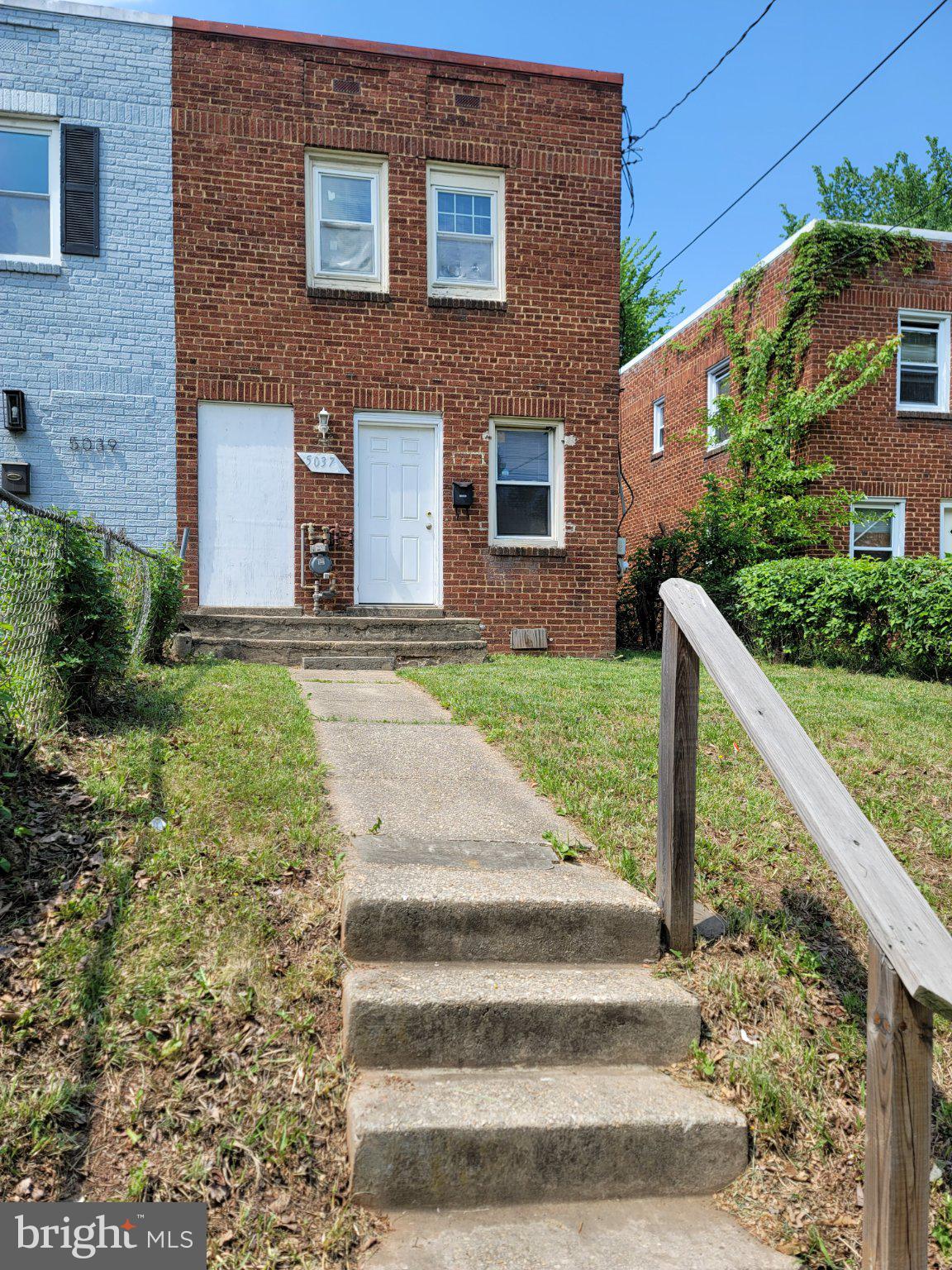 5037 Benning Road Southeast Washington, DC 20019 - Photo 2 of 8 a front view of a house with a yard