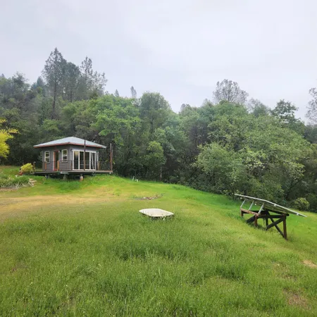 a view of a yard with a house in the background